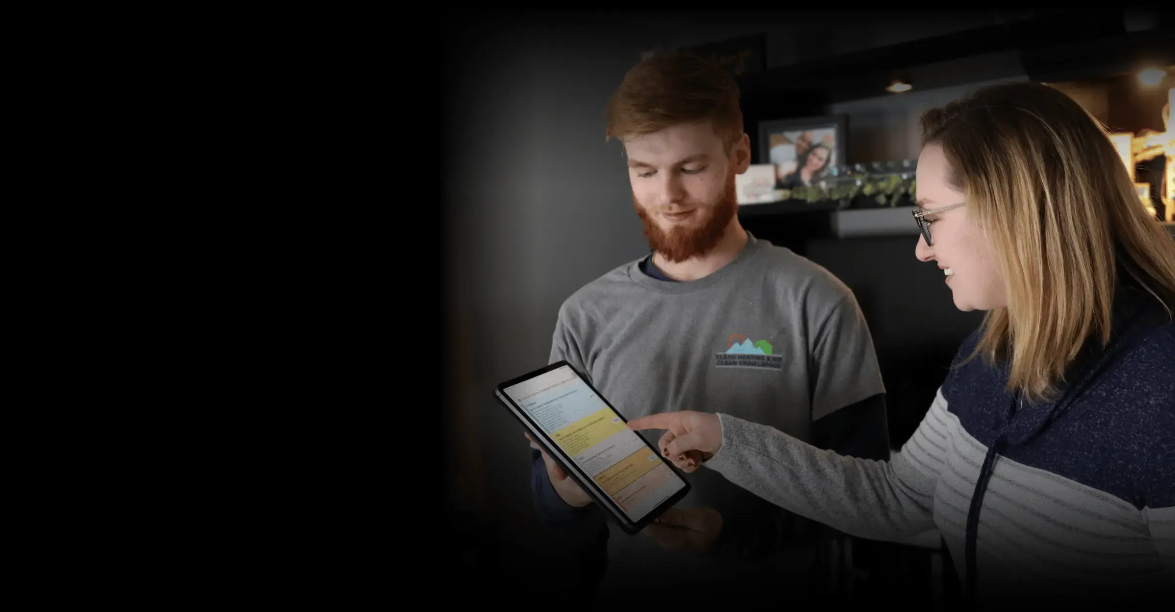 A technician showing pricing options to a homeowner on a tablet